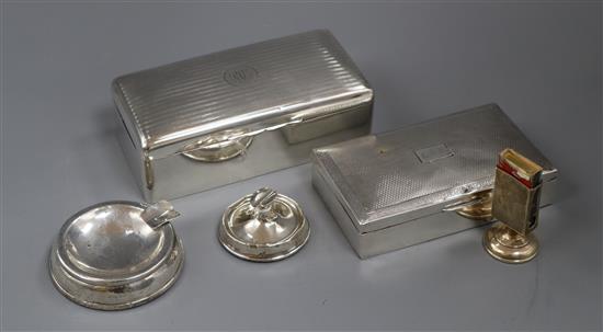Two silver cigarette boxes, engine-turned and monogrammed and a silver matchbox stand and two ashtrays (weighted)